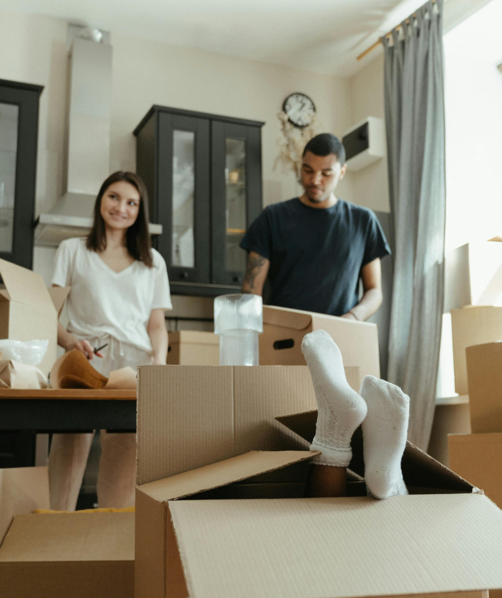 Family of three packing boxes in their home in BC after mortgage pre-approval in Vancouver